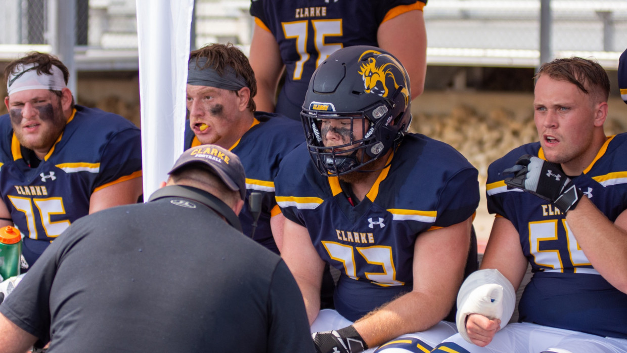 Pride football players on their bench