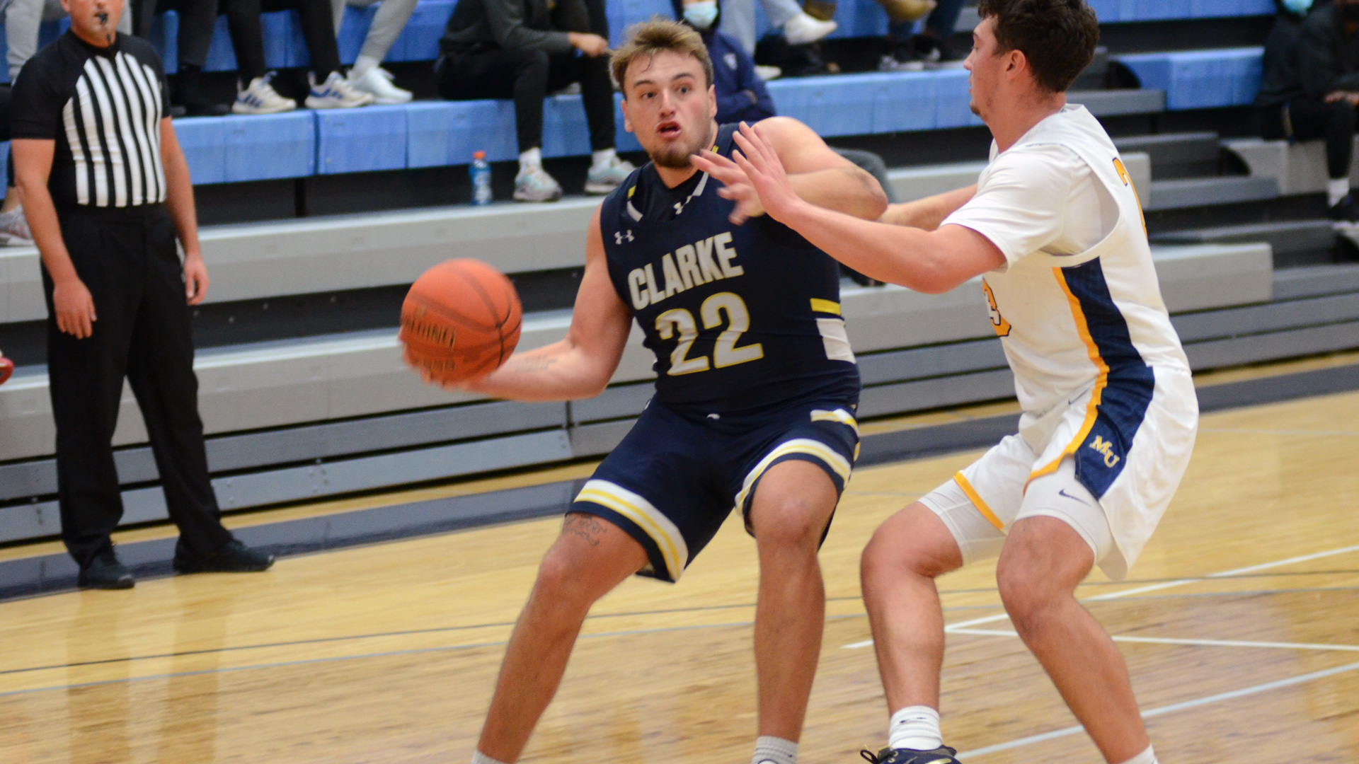 Clarke's Jacob Fierst driving towards the basket against a defender