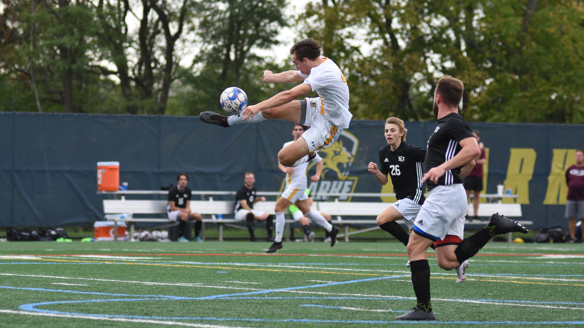 Clarke's Demitri Rede connecting on a scissor kick shot attempt